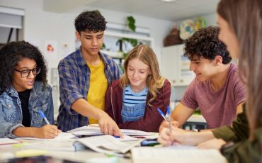 Multiethnic students studying together at secondary school